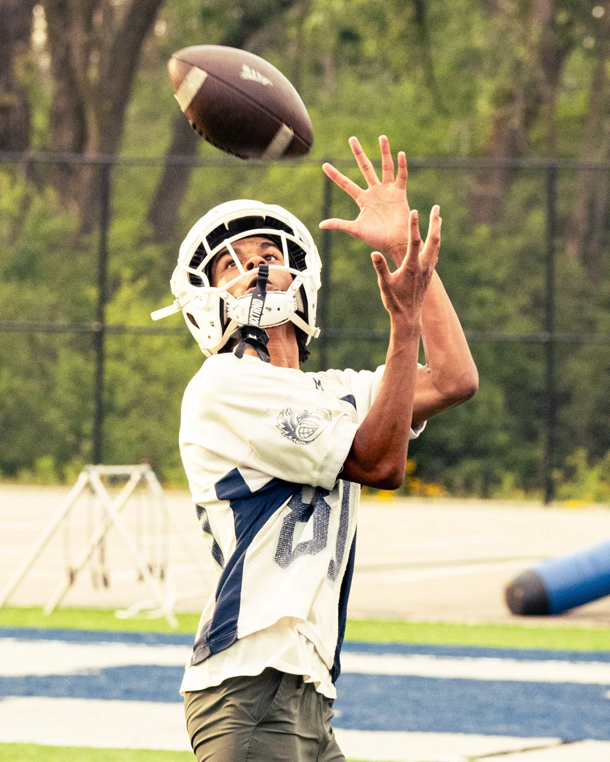 Football player reaching for a catch